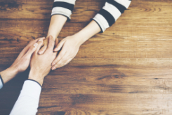 people holding hands on a table